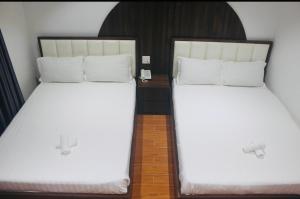 Postel nebo postele na pokoji v ubytování HAPPY HOTEL Tp Rạch Giá, Kiên Giang