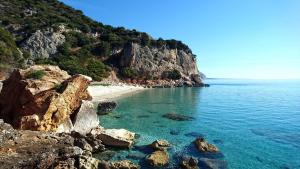 a view of a beach with rocks and the ocean at Safeheaven Sardinia in Dorgali