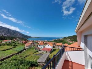 a view of a town from a balcony of a house at INcostadamorte Corral da Laxe in Dumbría