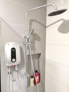 a shower in a bathroom with a phone on the wall at Paradigm Mall Perfect City View 4pax in Johor Bahru