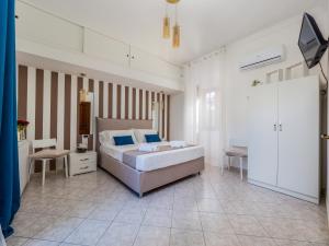 a bedroom with a bed and a table and chairs at Palazzo Russo - De Vivo Realty Piano di Sorrento in Piano di Sorrento