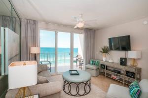 a living room with a couch and a tv at Majestic Sun 1108B in Destin