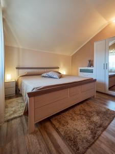 a bedroom with a large bed in a room at Villa Neval in Gostinjac