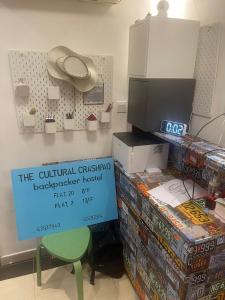 a room with a box of video games and a sign at The Cultural Crashpad - 康乃馨旅館 in Hong Kong