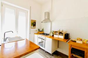 a kitchen with a sink and a stove top oven at PLANT HOUSE Roma San Paolo in Rome