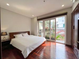 a bedroom with a bed and a large window at NINE HOUSING 535 Kim Ma in Hanoi