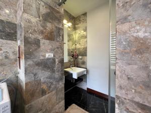 La salle de bains est pourvue d'un lavabo et d'une douche. dans l'établissement NINE HOUSING 535 Kim Ma, à Hanoï