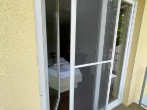 a glass door with a toilet inside of it at Küstenapartment 2 in Gelbensande +7 photos
