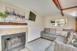 a living room with a couch and a fireplace at Cozy Hillside Hideaway in Wintergreen Resort! in Lyndhurst