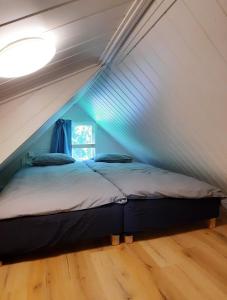 a bedroom with a bed in a attic at Davids Stuga in Klässbol