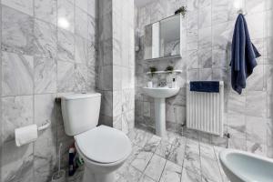 a white bathroom with a toilet and a sink at Apartment in Baker Street- Huge Balcony in London