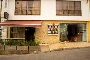 a store front of a building with a window at HBS Hotel in Manizales