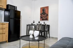 a kitchen with a table and a black refrigerator at Casa De Lago in Agios Nikolaos