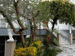 a group of trees and flowers in front of a building at Rachel's guest apartments in Santa Maria Capua Vetere