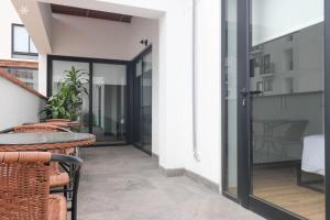a balcony with a table and chairs on a building at Beautiful 2BR with Terrace in Miraflores in Lima