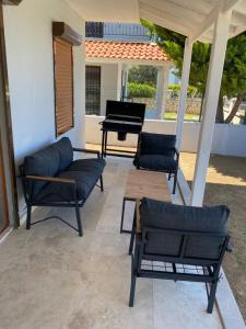 a patio with a couch and a piano at Dublex villa in Cesme