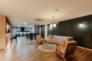 a living room with a couch and a table and chairs at 1616 Hotel in Medellín +35 photos