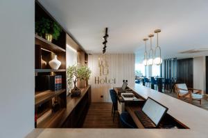 an office with a desk and a laptop on a counter at 1616 Hotel in Medellín