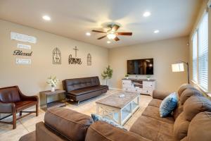 a living room with a couch and a tv at San Antonio Vacation Rental with Patio Near SeaWorld in San Antonio