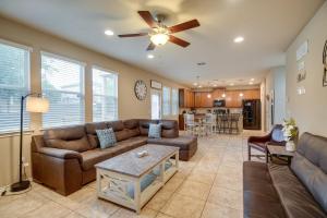 a living room with a couch and a ceiling fan at San Antonio Vacation Rental with Patio Near SeaWorld in San Antonio