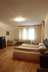 a large bedroom with a large bed and a couch at Eco Complex Smilyan in Smilyan