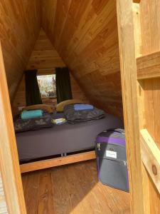 Cette petite chambre comprend deux lits et une valise. dans l'établissement Achterhoeks Goed, Minicamping in Vragender, à Vragender