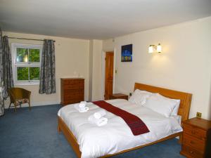 a bedroom with a bed with two towels on it at Heathfield in Taunton