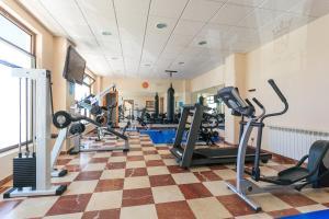 a gym with treadmills and cardio equipment in a room at Hotel Astuy in Isla