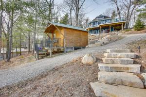 a log cabin on the side of a road at Sleeping Bear Lake Cabin Hot Tub, Dock and Sauna! in Honor