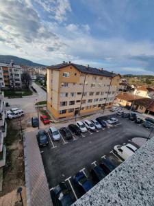 a parking lot with cars parked in front of a building at Stan Na dan Pale Ice1 in Pale