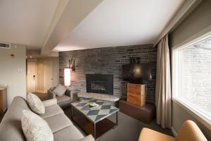 a living room with a couch and a fireplace at The Juniper Hotel & Bistro in Banff