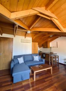 a living room with a blue couch and a table at Dinos Apartments in Vasiliki