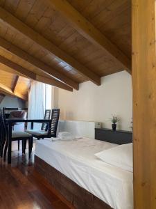 a bedroom with a bed and a table and chairs at Dinos Apartments in Vasiliki