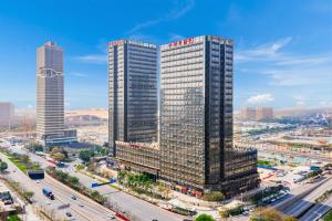 an aerial view of a tall building in a city at April Fair Duplex Apartment Guangzhou South Railway Station Ao Yuan Yue Shi Dai Branch in Guangzhou