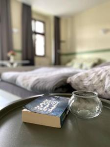 a book sitting on a table next to a bed at Apartment Sonnenterrasse in Bautzen