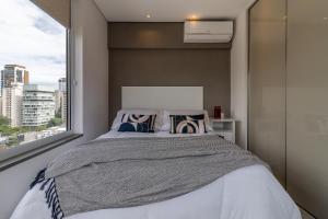 מיטה או מיטות בחדר ב-Akile Ferreira Lobo Itaim - VNCEL