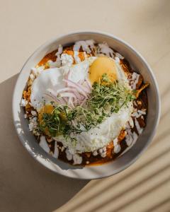 a bowl of food with an egg on top at Hotel Muaré & Spa Tulum in Tulum