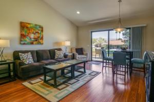 a living room with a couch and a table at Palm Desert Retreat - Patio, Grill and Pool Access! in Palm Desert