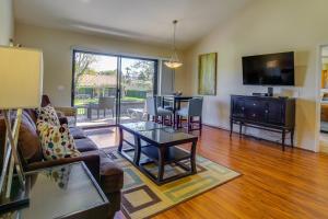 a living room with a couch and a table at Palm Desert Retreat - Patio, Grill and Pool Access! in Palm Desert
