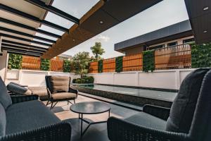 a rooftop patio with chairs and a table at Astro Luxury: Ultra Luxury 4 Beds Pool Villa in Nong Prue