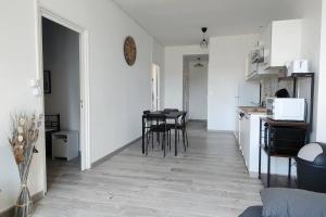 - une cuisine et une salle à manger avec une table et des chaises dans l'établissement Bel appartement centre ville., à Blaye