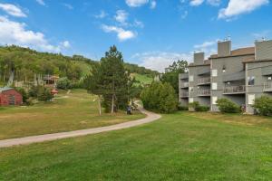 a path through a park next to a building at 2 BR Ski In Out at Cachet Crossing, Sleeps 8 in Blue Mountains