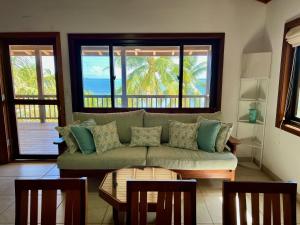a living room with a couch and a table at Bella Sway Belize in Placencia