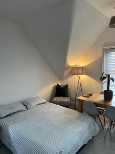 a bedroom with a bed and a desk and a chair at 1 or 2 bed in Folkestones West End in Folkestone