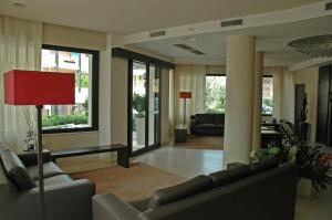 a living room with couches and a red lamp at Residence San Paolo in Lido di Savio