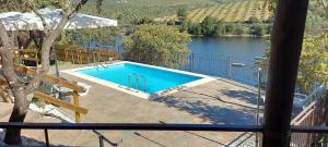 a swimming pool with a view of a lake at Complejo Rural El Recuerdo in La Pesga