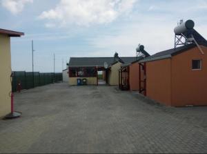 a building with a parking lot next to it at Mara si Marea in Năvodari +4 photos