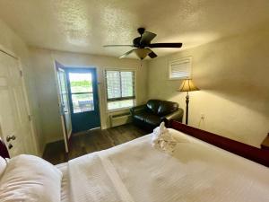 a bedroom with a bed and a ceiling fan at Lake view queen Guest Room with two queens, sleeper sofa and deck overlooking Lake Ouachita, Hotel Room in Mount Ida