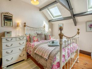 a bedroom with a bed and a dresser and a window at Ty Ysgubor - Jyz in Gowerton