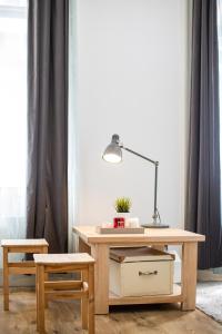 a desk with a lamp and a chair in a room at Paco&Orsi's homey cosy apartment in the city center in Budapest